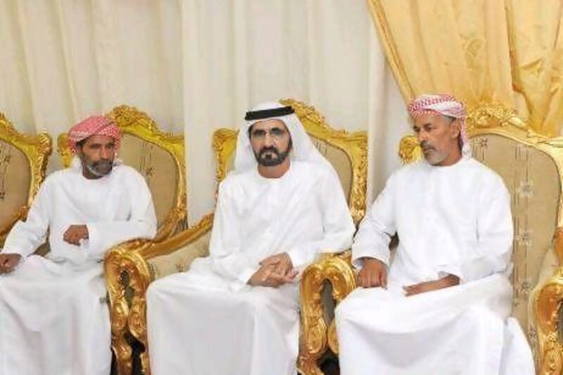 Sheikh Mohammed bin Rashid, Vice President and Ruler of Dubai, offers condolences to Col Saif’s brothers, Rashid Abdulla Al Hajj Al Kaabi, left, and Salem Abdulla Al Hajj Al Kaabi in Al Ain.