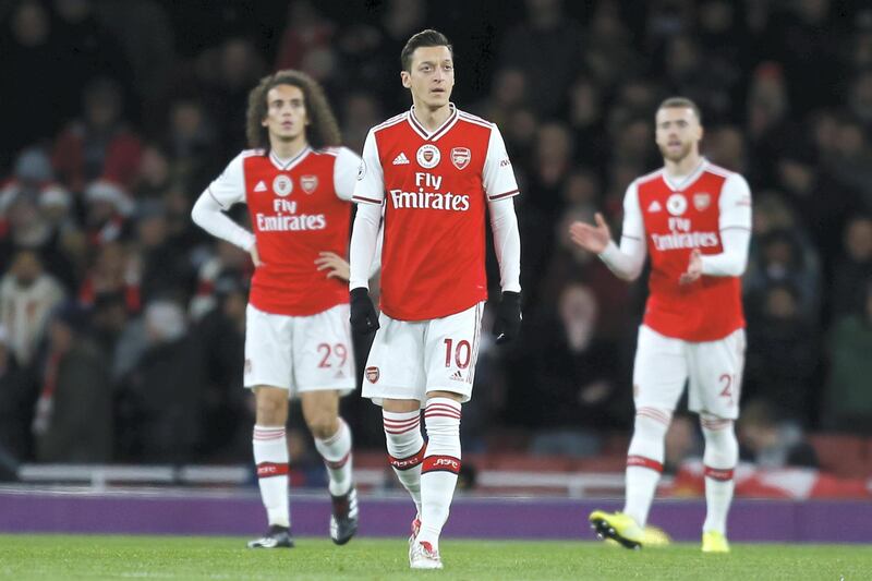 Arsenal's German midfielder Mesut Ozil (C) reacts after going 1-0 behind during the English Premier League football match between Arsenal and Manchester City at the Emirates Stadium in London on December 15, 2019. (Photo by Ian KINGTON / IKIMAGES / AFP) / RESTRICTED TO EDITORIAL USE. No use with unauthorized audio, video, data, fixture lists, club/league logos or 'live' services. Online in-match use limited to 45 images, no video emulation. No use in betting, games or single club/league/player publications.