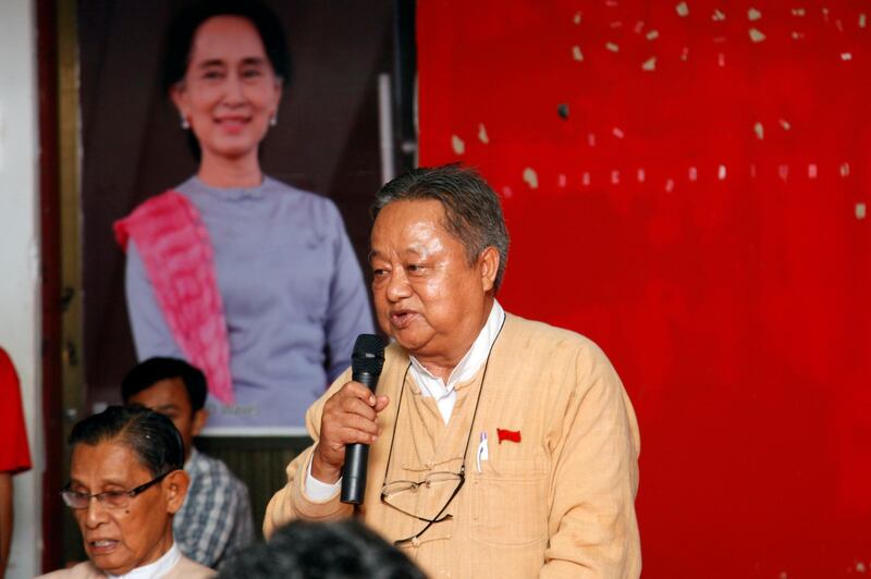 FILE - In this Aug. 6, 2014, file photo, Win Htein, a parliament member of Myanmar Opposition Leader Aung San Suu Kyi's National League for Democracy party, talks to journalists during a press conference on a campaign to collect signatures to amend 2008 constitution jointly organized by opposition NLD party and Myanmar prominent 88 Generation Students Group, along with Tin Oo, left, senior leader of NLD, in front of portrait of Suu Kyi at the headquarter of NLD in Yangon, Myanmar. Win Htein has become the latest prominent politician arrested as the country's new military government confronts continuing resistance to its seizure of power. (AP Photo/Khin Maung Win, File)
