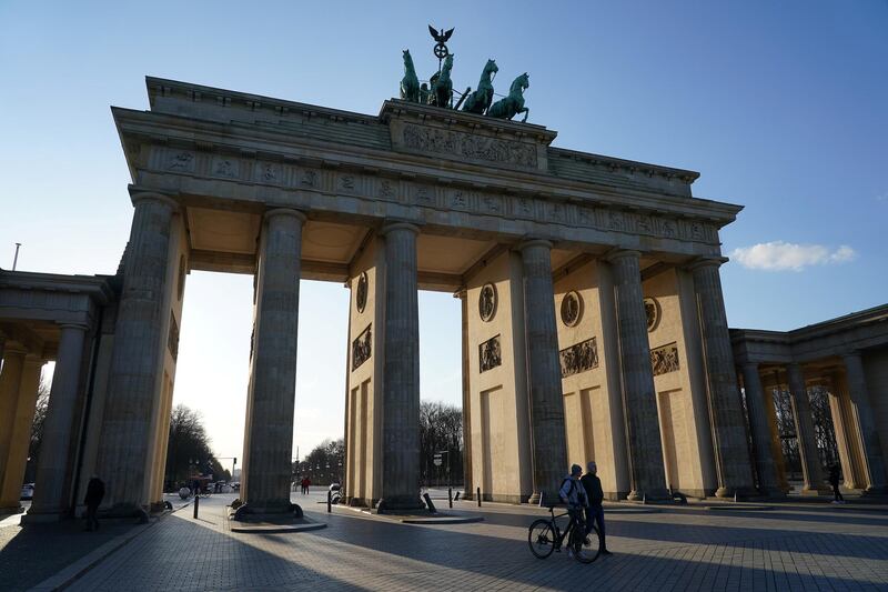 BERLIN, GERMANY - MARCH 16: The Brandenburg Gate, a popular landmark and tourist destination, stands nearly devoid of visitors on March 16 in Berlin, Germany. Everyday life in Germany has become fundamentally altered as authorities tighten measures to stem the spread of the coronavirus. Businesses depending on tourism are seeing a collapse in reservations and attendance. Public venues such as bars, clubs, museums, cinemas, schools, daycare centers and universities have closed. Many businesses are resorting to home office work for their employees. And travel across the border to most neighboring countries is severely restricted.  (Photo by Sean Gallup/Getty Images)