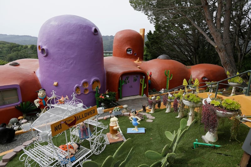 The San Francisco Bay Area suburb of Hillsborough argued the home's owner installed dangerous steps, dinosaurs and other Flintstone-era figurines without necessary permits. AP