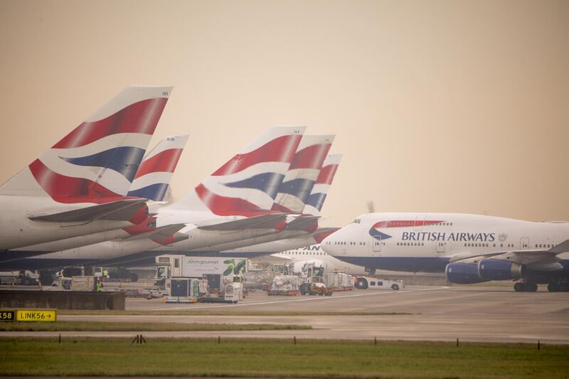 A passenger aircraft operated by British Airways, a unit of International Consolidated Airlines Group SA (IAG), taxis past other standing British Airways aircraft at Terminal 5 at London Heathrow Airport in London, U.K., on Monday, Dec. 24, 2018. British Airways-owner International Consolidated Airlines Group SA and budget carriers EasyJet Plc and Ryanair Holdings Plc all have significant revenue exposure to the U.K., according to analysts at Bernstein. Photographer: Jason Alden/Bloomberg
