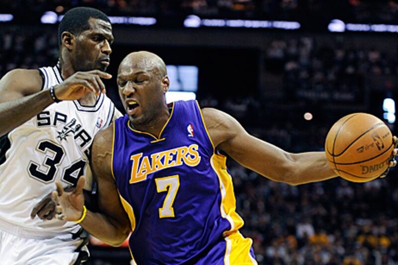 Lamar Odom, right, drives against Spurs forward Antonio McDyess during the LA Lakers win in San Antonio.