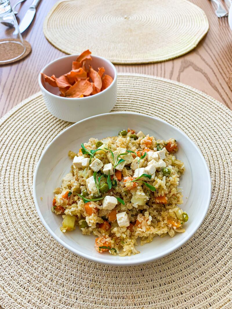 One of the lunch offerings prepared on-site is the vegan biriyani, served with dehydrated carrots as a snack. Photo: Jason Von Berg / The National