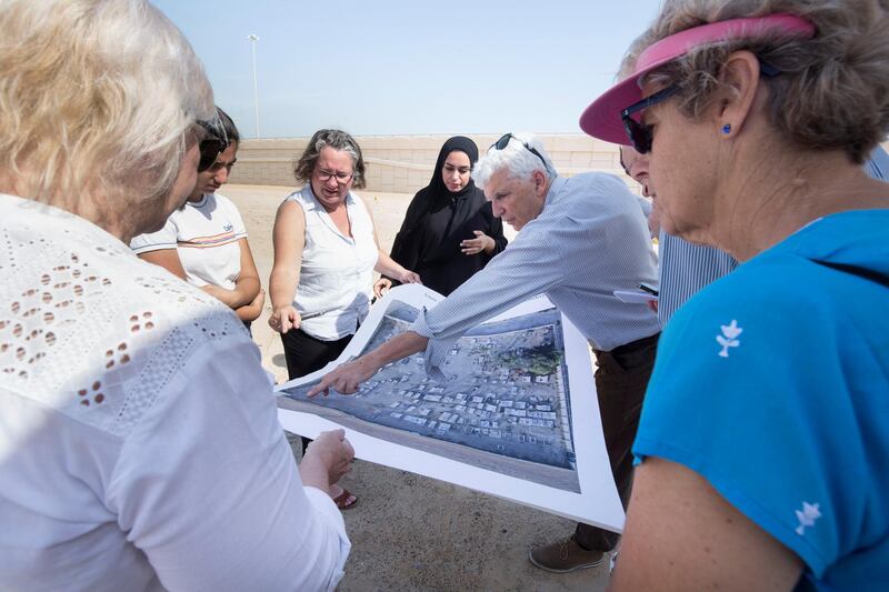 ABU DHABI, UNITED ARAB EMIRATES - Prof. Athol Yates of Khalifa University with his team pointing at a map of the cemetery at Sas Al Nakhel Cemetery, Non Muslim.  Ruel Pableo for The National for John Dennehy's story