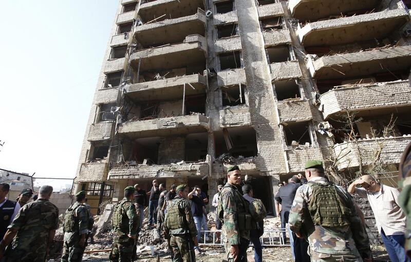 Lebanese security forces stand guard near a damaged building at the scene of a powerful blast in southern Beirut which killed at least 10 people on November 19, 2013 near the Iranian embassy, according to police and security sources. Anwar Amro / AFP