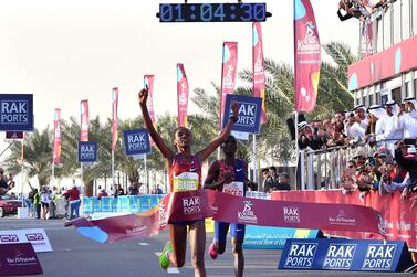 Ababel Yeshaneh crosses the finish line of RAK Half Marathon and breaks the world record in Ras Al Khaimah. AFP