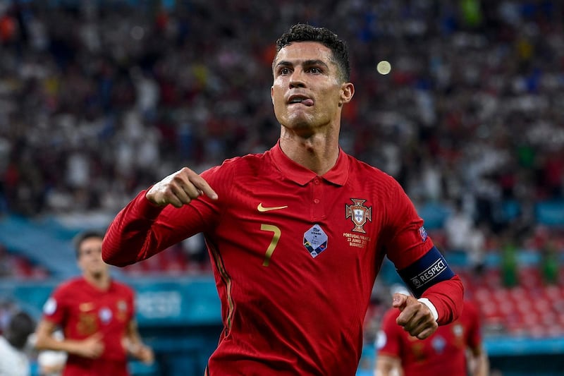 epa09297310 Cristiano Ronaldo of Portugal celebrates aftter he scored a goal during the Portugal vs. France match in the third round of Group F of the Euro 2020 soccer tournament in Puskas Ferenc Arena in Budapest, Hungary, 23 June 2021.  EPA/Zsolt Szigetvary HUNGARY OUT