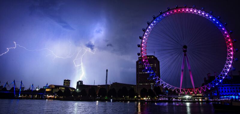 Lightning strikes behind The London Eye in central London which is lighted up in the national colors of red, white and blue to mark the birth of Prince William and his wife Kate's first child Tuesday, July 23, 2013. (AP Photo/PA, Lewis Whyld) UNITED KINGDOM OUT, NO SALES, NO ARCHIVES *** Local Caption ***  Britain Royal Baby.JPEG-0e06d.jpg