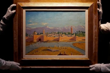 Christie's employees adjust an oil on canvas painting by Sir Winston Churchill painted in Jan. 1943 called 'Tower of the Koutoubia Mosque'. AP