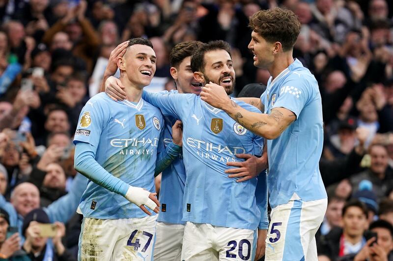 Manchester City's Phil Foden celebrates with teammates after scoring their second goal. PA 