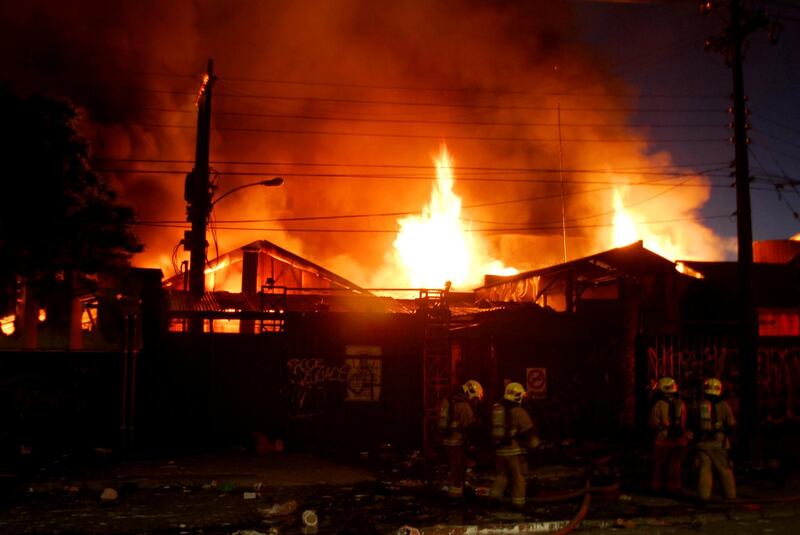 Fire fighters battle a fire destroying a home improvement retailer as protests against high living costs continue, in Concepcion, Chile. Reuters