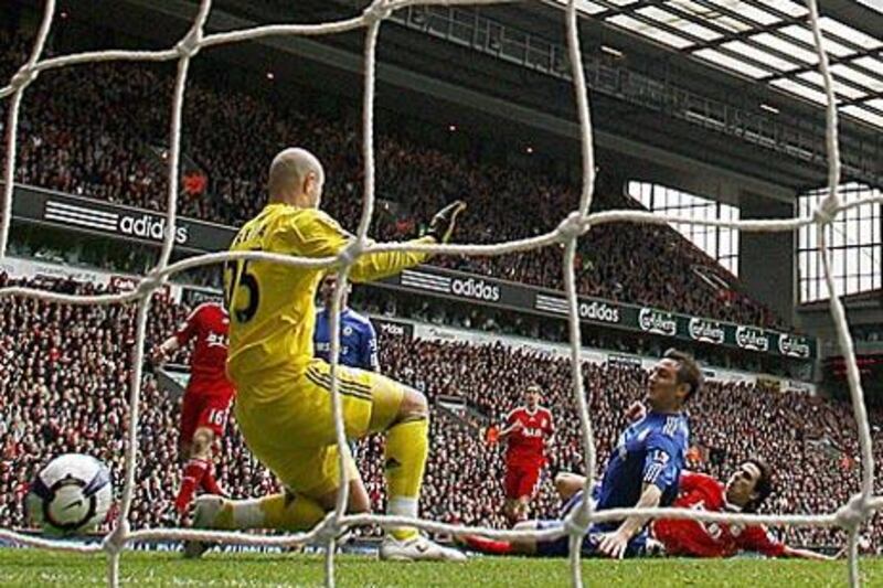 Frank Lampard, blue, slides in to score Chelsea's second goal to help his side to a 2-0 win over Liverpool at Anfield.