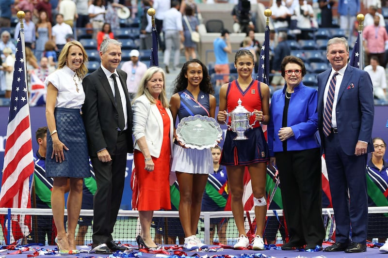 Leylah Annie Fernandez of Canada holds the runner-up trophy as Emma Raducanu of Great Britain celebrates with the championship trophy alongside Billie Jean King, Stacey Allaster, USTA Chief Executive, and USTA President Mike McNulty. AFP