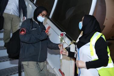 A Hope probe team member is greeted with flowers on her return to the UAE. Courtesy Abu Dhabi Airports
