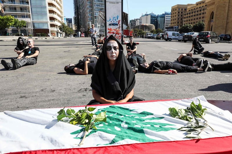 Lebanese anti-government protesters take part in a symbolic funeral for the country in the central area of the capital Beirut on the third consecutive day of demonstrations over a deepening economic crisis.  AFP