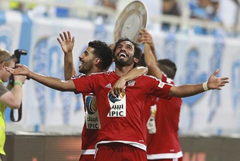 Salim Rashid and Mbark Boussoufa celebrate after Al jazira clinched the Arabian Gulf League title. Hassan Al Raisi / Aletihad