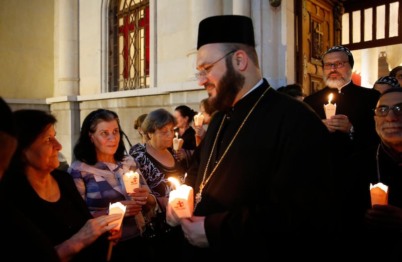 Clergymen participate in a candlelight vigil in Damascus, Syria, to commemorate the lives lost in the Assyrian Genocide. EPA