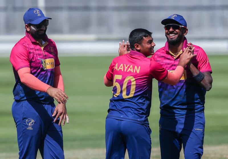 Aayan Khan of the UAE celebrates with his teammates after taking a wicket against Namibia during their Cricket World Cup League 2 match at the Dubai International Stadium on Thursday, February 23, 2023. All images Victor Besa / The National