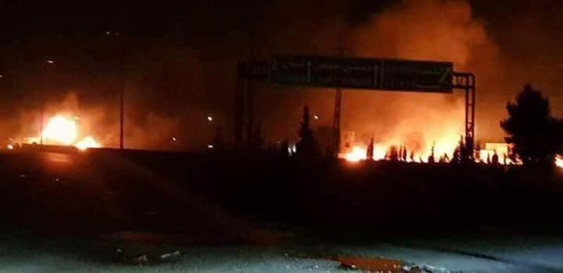 This photo released on Wednesday, May 9, 2018, by the Syrian official news agency SANA, shows flames rising after an attack in an area known to have numerous Syrian army military bases, in Kisweh, south of Damascus, Syria. Syrian state-run media said Israel struck a military outpost near the capital Damascus on Tuesday, saying its air defenses intercepted and destroyed two of the incoming missiles. The reported attack came shortly after U.S. President Donald Trump announced he was withdrawing from the Iran nuclear deal, calling Tehran a main exporter of terrorism in the region. (SANA via AP)