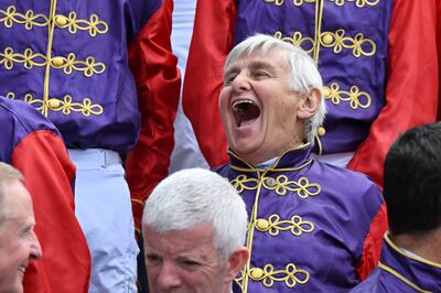 Former jockey Willie Carson, who won a Classic for the queen in her silver jubilee year, shares a lighter moment with the other riders. AFP