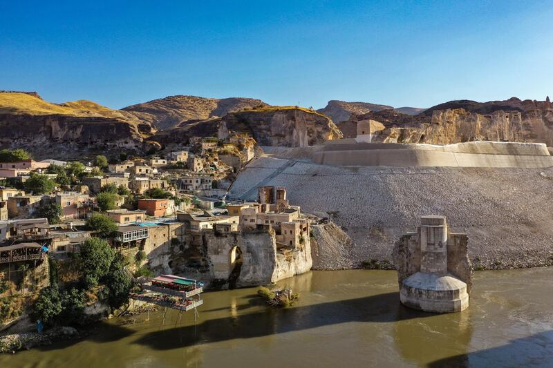 HASANKEYF, TURKEY - OCTOBER 01: Ancient town of Hasankeyf is seen by the Tigris river, which will be significantly submerged by the Ilisu dam on October 01, 2019 in Hasankeyf, Turkey.  The ancient Silk Road trading post of Hasankeyf, which sits on the banks of Tigris River in southeast Turkey, will soon be flooded by the Ilisu Dam. Hasankeyf is thought to be one of the oldest continuously inhabited settlements on Earth, dating as far back as 12,000 years. It will be completely submerged when a reservoir behind the new Ilisu Dam causes the river to rise some 60 meters in a few months. Ilisu is the fourth biggest dam in Turkey and is a key part of Turkeys Southeastern Anatolia Project (GAP), designed to improve its poorest and least developed region. In 2006 the Turkish government officially began work on the giant dam across the Tigris River, which will lead to the submerging of an estimated 80 percent of Hasankeyf and the displacement of its 3,000 residents, as well as many other people. The Ilisu dam and the Hydra Electric Power Plant will help fulfil the country's energy needs and provide irrigation to the agricultural lands surrounding it. Once activated, the power plant will generate 3,800 gigawatts hours of electricity annually. The project will affect 199 settlements in the area and push thousands of people out of their homes and away from their livelihoods. The government has built a new town with 710 houses for the Hasankeyf residents 3 kilometers away from the ancient town. Eight monuments have also been relocated to safer ground near the new settlement but the rest of the city, with all its rich history, will be inundated. Only the citadel will still be visible above the water. The Turkish government has given residents until 8 October to evacuate.  (Photo by Burak Kara/Getty Images)