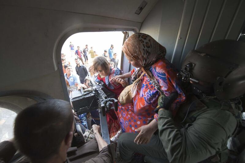 Women and children are evacuated in a military helicopter by Iraqi forces from Amerli, north of Baghdad August 29, 2014. The Unted States carried out airstrikes against ISIL targets near Amerli on Saturday, as President Barack Obama authorised the new military action amid an international outcry over the threat to Amerli’s mostly ethnic Turkmen population. Reuters