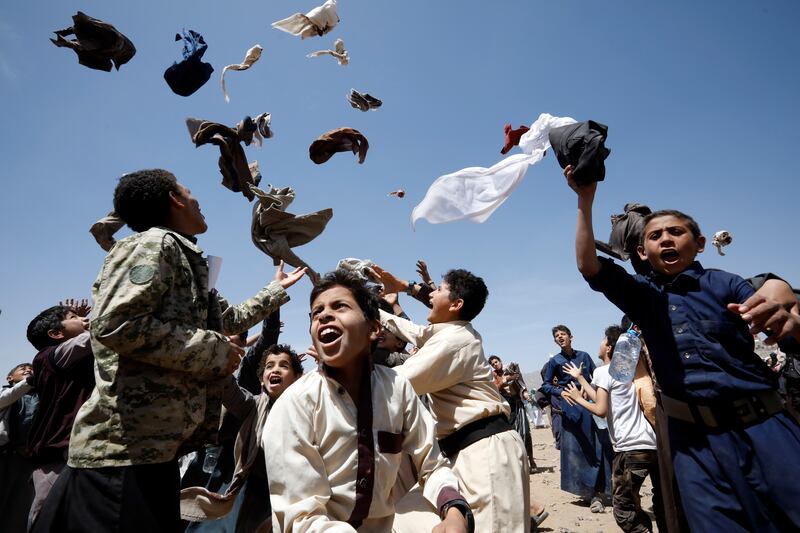 Yemeni boys toss pieces of their clothes in the air on a hot day in Sanaa. Yemen's meteorological service has warned of a heatwave and dry weather in most parts of the country, which is experiencing a lack of much-needed rainfall. EPA