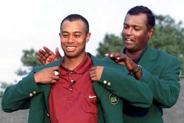 Tiger Woods (L) of the US gets his second green jacket from 2000 Masters Champion Vijay Singh (R) of Fiji 08 April, 2001 after the final round of the 2001 Masters Golf Tournament at the Augusta National Golf Club in Augusta, Georgia. Woods won the Masters by one stroke in Augusta 08 April to become the first golfer in history to hold all four professional Major titles at one time. AFP PHOTO/Timothy A. CLARY (Photo by TIMOTHY A. CLARY / AFP)