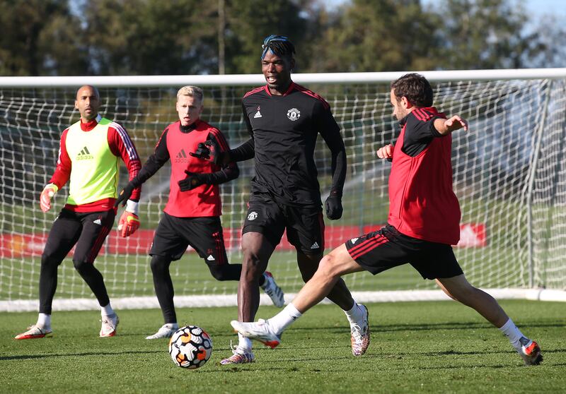 MANCHESTER, ENGLAND - OCTOBER 21: (EXCLUSIVE COVERAGE) Paul Pogba and Juan Mata of Manchester United in action during a first team training session at Carrington Training Ground on October 21, 2021 in Manchester, England. (Photo by Matthew Peters/Manchester United via Getty Images)