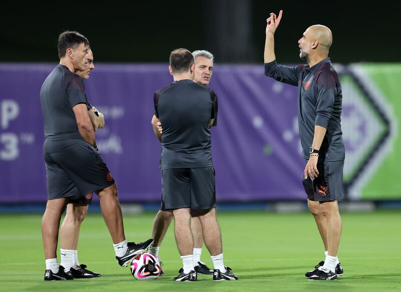 Manchester City manager Pep Guardiola speaks with his coaching staff. EPA 