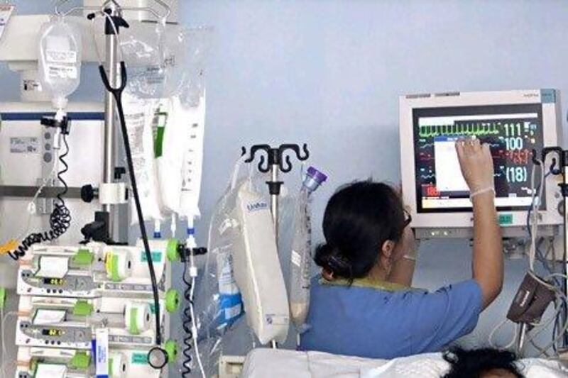A nurse checks a patient's vital signs on a monitor in the intensive care unit of Rashid Hospital in Dubai. The Gulf's healthcare industry, which is projected to grow to US$11.9 billion in 2015, is attracting companies from Germany, China, the United States and the United Kingdom. Jeff Topping / The National