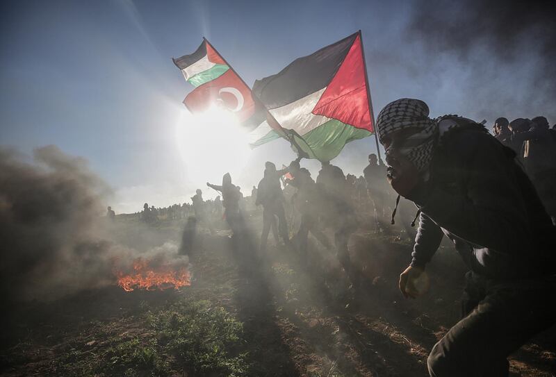 Palestinian protesters take part in the clashes after protests near the border between Israel and Gaza Strip, east Gaza.  EPA