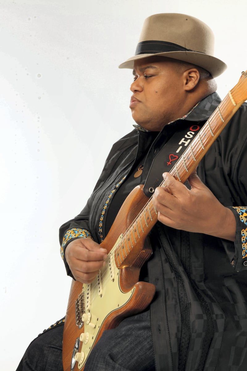 Portrait of American musician Toshi Reagon as she plays guitar against a white background, New York, New York, 2012. (Photo by Anthony Barboza/Getty Images)