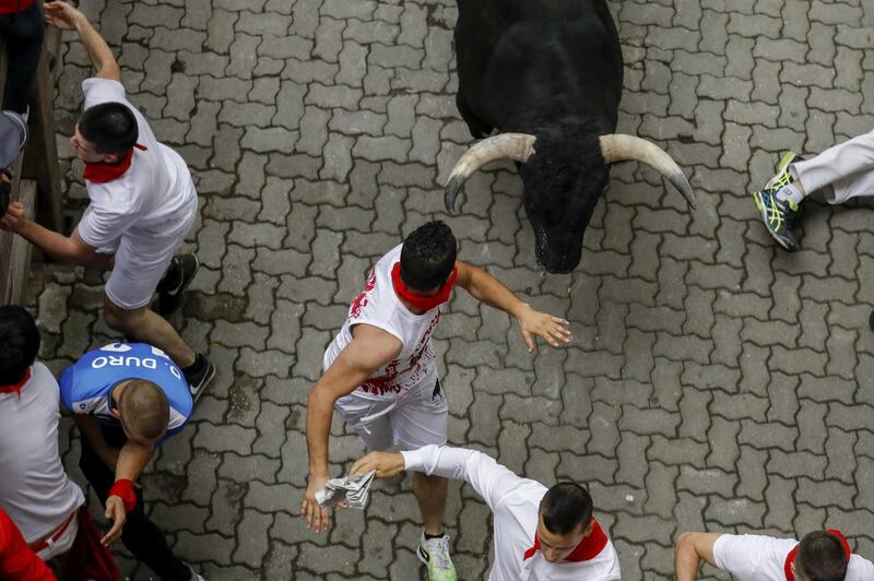 Revellers run with Puerto de San Lorenzo's fighting bulls before entering the bullring during the second day of the San Fermin Running of the Bulls festivalin Pamplona, Spain. Getty Images