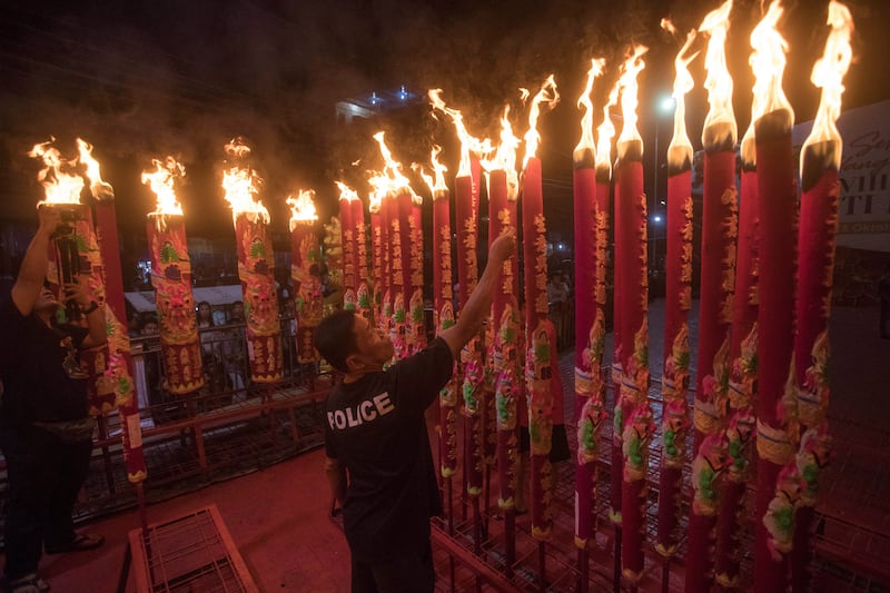 An Indonesian-Chinese man lights incense sticks during the Lunar New Year celebrations at a temple in Medan, North Sumatra, Indonesia. AP Photo
