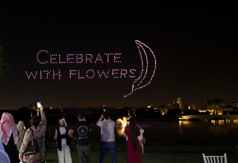 Drones spell out 'celebrate with flowers'.