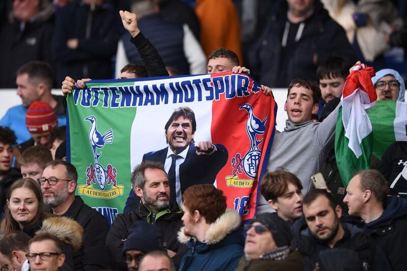 Tottenham fans hold a banner of the club's new manager Antonio Conte. AFP