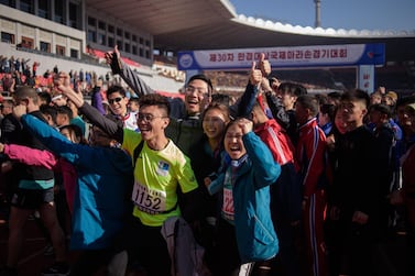 Foreign competitors cheer as they pose for photos at the starting line of the annual Mangyongdae Prize International Marathon, at the Kim Il Sung stadium in Pyongyang. AFP