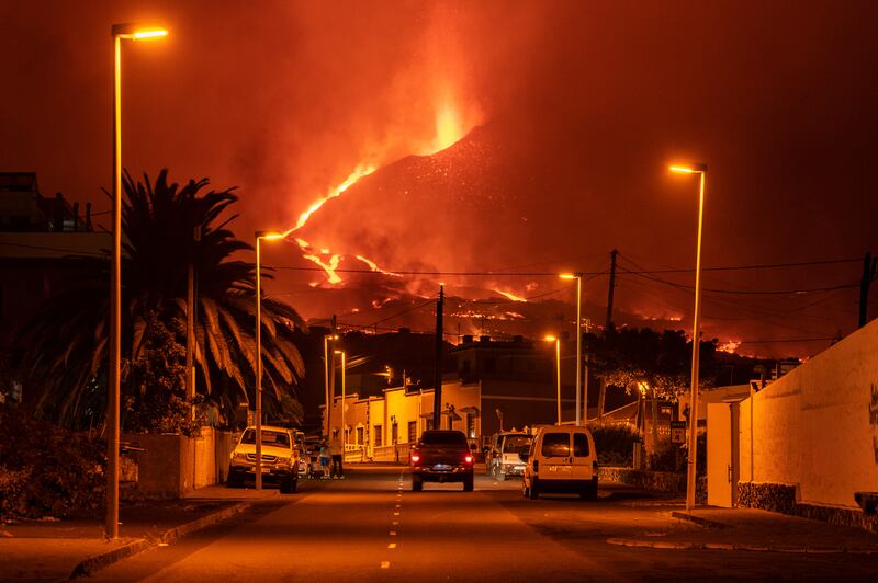 A car drives through an empty street in the neighbourhood of La Laguna as lava flows from the Cumbre Vieja volcano on the Spanish island of La Palma. Getty Images
