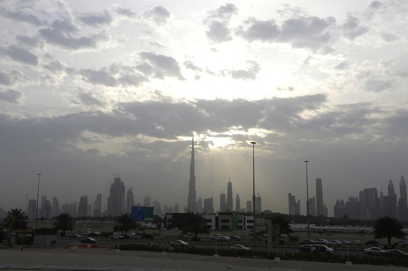 Clouds hug the Dubai skyline as the sun briefly peaks out. Jeffrey E Biteng / The National