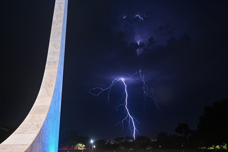 A lightning strike lights up the sky during a rainstorm in the background of the Supreme Federal Court (STF) in Brasilia, Brazil, 28 September 2023.   EPA / Andre Borges