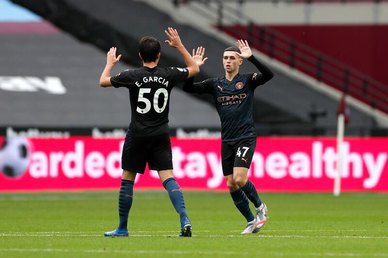 Manchester City's Phil Foden celebrates with Eric Garcia after levelling the score at 1-1 against West Ham United on Saturday, October 24. Getty
