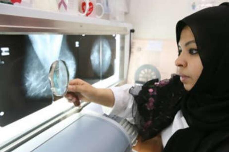 Dr Jalaa Taher examines x-rays at the National Health Screening Program for Women and Children.