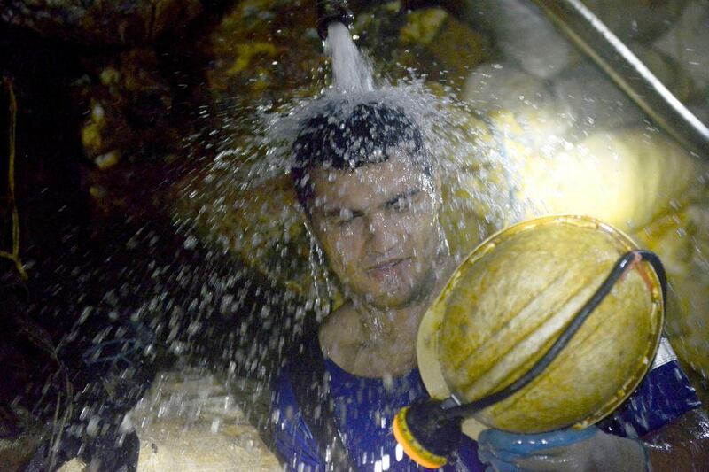 A miner cools himself down at 'La Primavera', a licensed gold mine in Segovia. Colombia has more than 14,350 mines, more than half of which operate without proper permits. Raul Arboleda / AFP