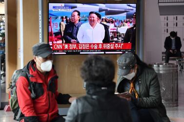 People at a railway station in Seoul watch a television news broadcast on April 21, 2020 showing file footage of North Korean leader Kim Jong-un. AFP  