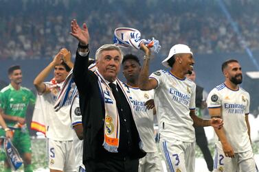 Real Madrid's Italian coach Carlo Ancelotti waves as he walks on the pitch with his players during the club's celebration of their 14th European Cup at the Santiago Bernabeu stadium in Madrid on May 29, 2022, a day after beating Liverpool in the UEFA Champions League final in Paris.  - Real Madrid claimed a 14th European Cup as Vinicius Junior's goal saw them beat Liverpool 1-0 in the Champions League final at the Stade de France amid chaotic scenes yesterday.  (Photo by OSCAR DEL POZO  /  AFP)