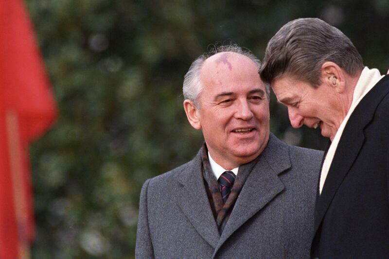 FILE - U. S.  President Ronald Reagan, right, talks with Soviet leader Mikhail Gorbachev during arrival ceremonies at the White House where the superpowers begin their three-day summit talks in Washington, D. C. , Tuesday, Dec.  8, 1987.  Russian news agencies are reporting that former Soviet President Mikhail Gorbachev has died at 91.  The Tass, RIA Novosti and Interfax news agencies cited the Central Clinical Hospital.  (AP Photo / Boris Yurchenko, File)