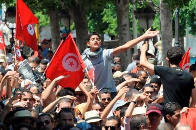 Tunisians protest against the government on Habib Bourguiba Avenue in the capital Tunis yesterday. Fethi Belaid / AFP