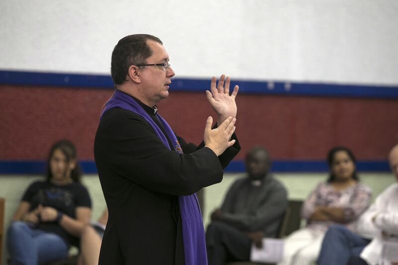 Reverend Canon Andrew Thompson leads a sermon at St Andrew's Church in Abu Dhabi.   (Silvia Razgova / The National) 